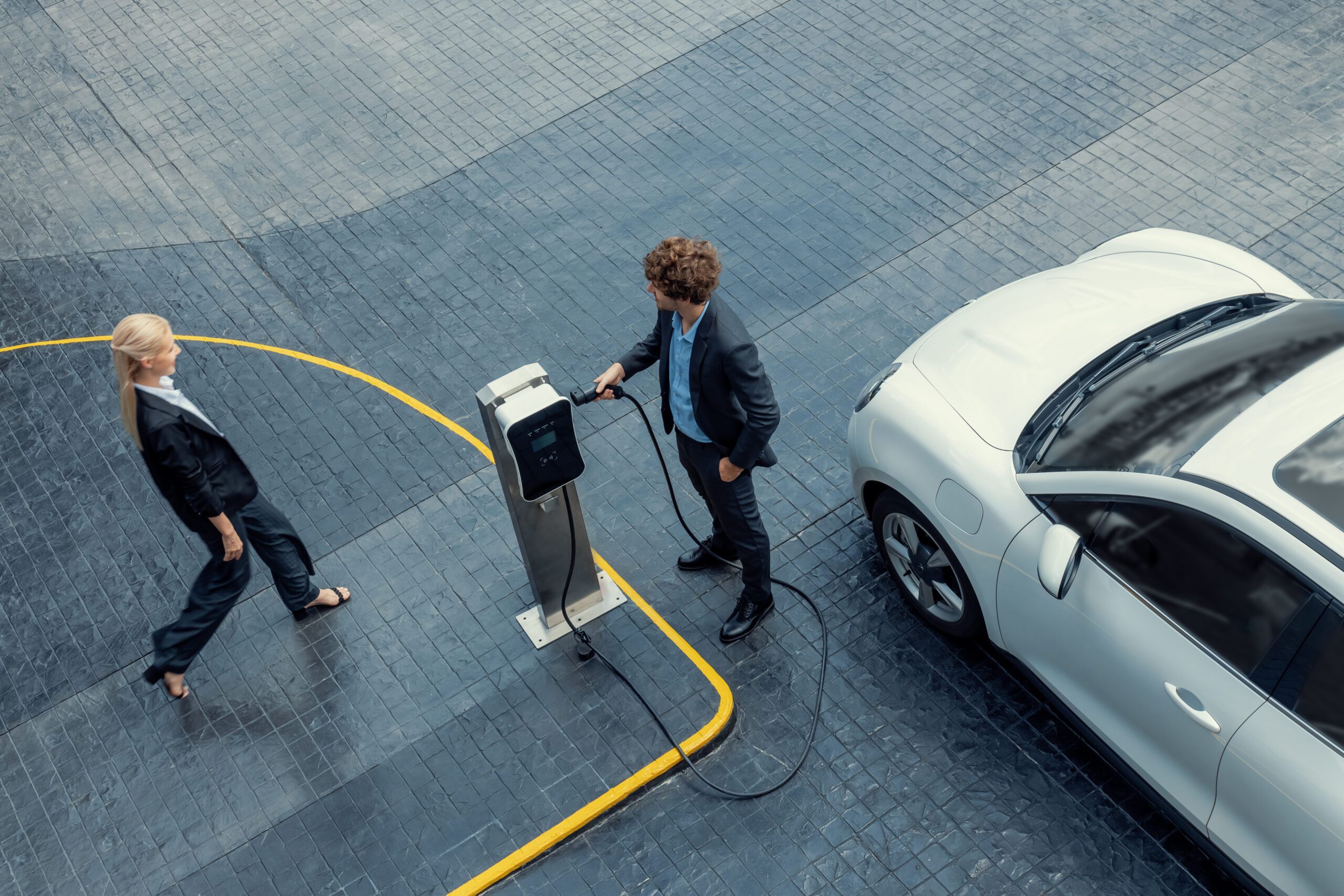 Aerial View Progressive Businesspeople With Ev Car And Charging Station.